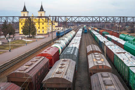 Freight wagons at the station. Rail transportation. Freight. A train carrying wood, timber. Trade blockadeの写真素材