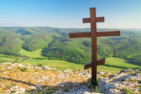 Orthodox cross on top of a mountain. Spring landscapeの写真素材