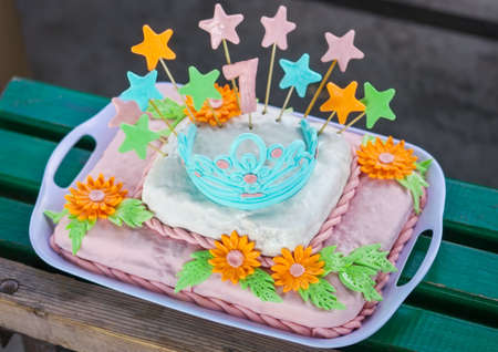Birthday cake with colorful flowers, stars and diademの写真素材