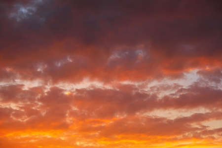 Fiery, orange and red colors sunset sky as backgroundの写真素材