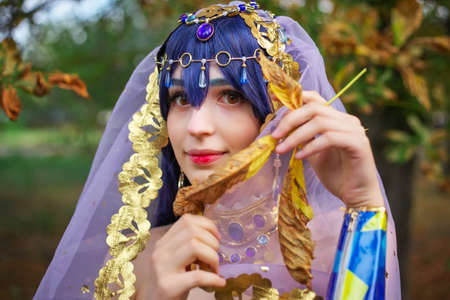 Beautiful girl in original suit, cosplay character in autumn park. Anime festivalの写真素材
