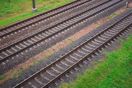 Three railway tracks and green grass as a background. Top view.の写真素材