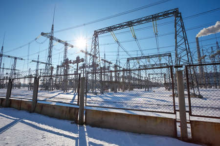 High voltage power lines in the winter. Thermal power plant. High-voltage transformer substation.