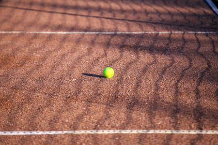 Tennis ball on a clay court. Sport backgroundの写真素材
