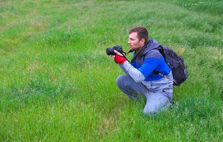 Photographer takes photos on the grass in the springtimeの写真素材