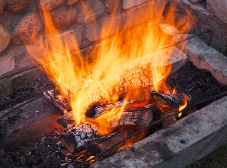 Burning firewood in the fireplace close upの写真素材