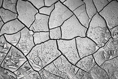 Dried cracked earth soil ground texture background. Mosaic pattern of sunny dried earth soilの写真素材