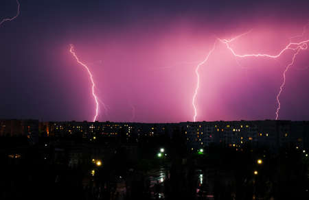 Lightning strikes down over the city at night. Beautiful shot. Long Exposure Photographyの写真素材