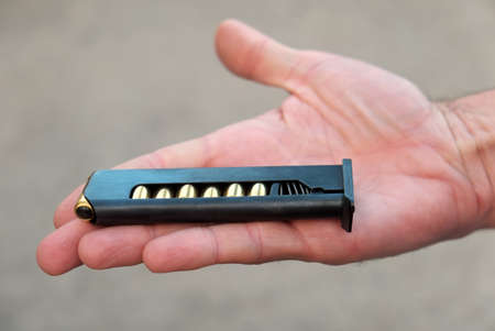 The clip from the Makarov pistol in his hand. Close-up. Protection, self-defense.の写真素材