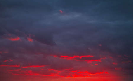 Beautiful bright colorful sky. Picture taken at sunset. Red-orange background with nice paints. Rare sunrise. Natural compositionの写真素材