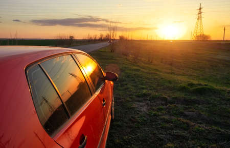 Angle shot of a car against sunset in the backgroundの写真素材