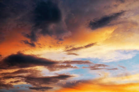 Beautiful dark fluffy cloudy sky. Sunset light.