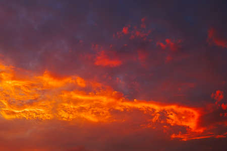 Beautiful fiery, orange and red, sunset sky. Evening Magic Scene. Composition of natureの写真素材