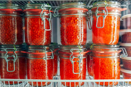 Jars with delicious red caviar in the fridge. Delicious expensive snackの写真素材