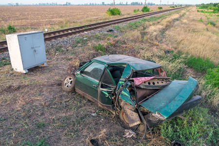 The car had an accident at a railway crossing. Passenger car collided with a train.の写真素材