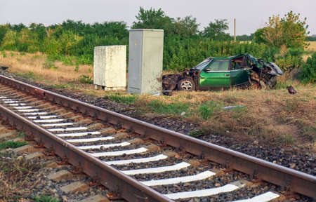 The car had an accident at a railway crossing. Passenger car collided with a train.の写真素材