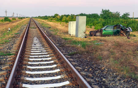 The car had an accident at a railway crossing. Passenger car collided with a train.の写真素材