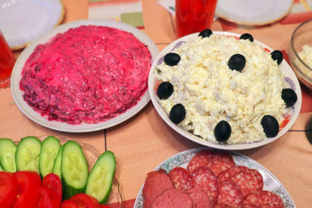 Russian homemade food. Delicious food on the table. Fish salads, vegetables, sandwiches, drinks
