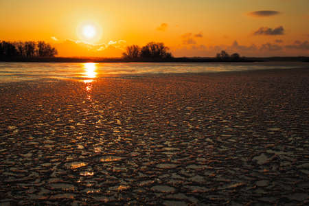 Sunrise and frozen river. Beautiful winter landscape with lake in morning time. Daybreakの写真素材