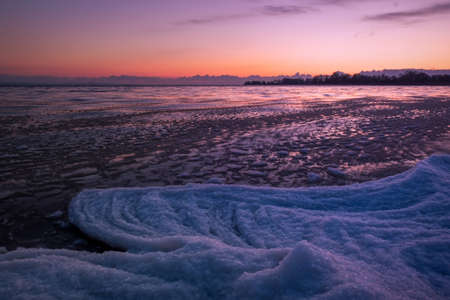 Sunrise and frozen river. Beautiful winter landscape with lake in morning time. Daybreakの写真素材