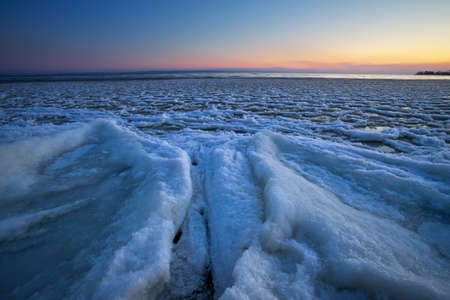 Sunrise and frozen river. Beautiful winter landscape with lake in morning time. Daybreakの写真素材