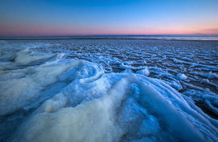 Sunrise and frozen river. Beautiful winter landscape with lake in morning time. Daybreakの写真素材