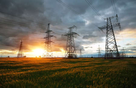 Silhouette High voltage electric towers at sunset time. High-voltage power lines. Electricity distribution stationの写真素材