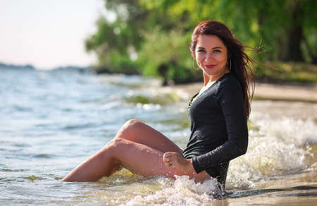 Beautiful attractive sexy girl on the beach in sunny dayの写真素材
