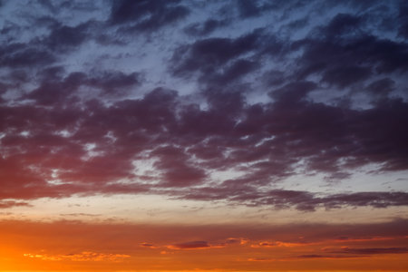 Sky sunset in the evening with colorful orange sunlight. Beautiful majestic nature background