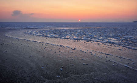 Sunrise and frozen sea. Beautiful winter landscape with lake in morning time. Daybreak