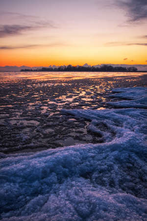 Winter landscape with sunset sky and frozen river. Daybreakの写真素材