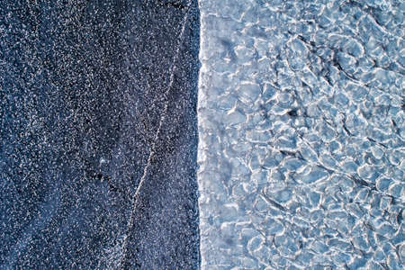 Frozen ice on the shore of the reservoir as a background, a bird's-eye view.の写真素材