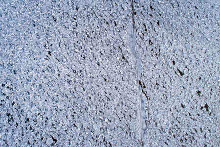 Frozen ice on the shore of the reservoir as a background, a bird's-eye view.の写真素材