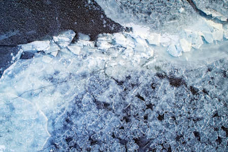 Frozen ice on the shore of the reservoir as a background, a bird's-eye view.の写真素材