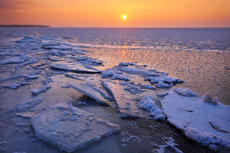 Sunrise and frozen sea. Beautiful winter landscape with lake in morning time. Daybreakの写真素材