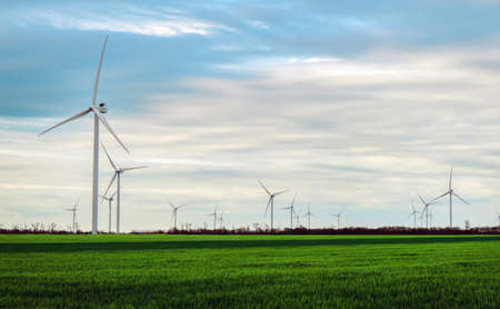 Wind turbines generating electricity with blue sky - energy conservation conceptの写真素材