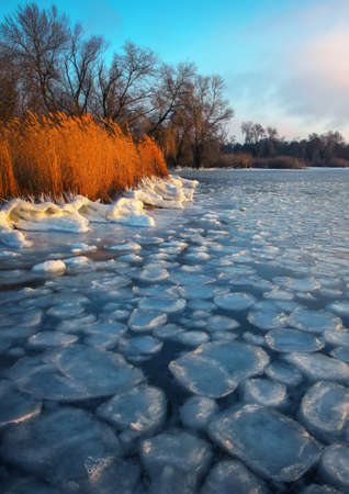 Sunrise and frozen sea. Beautiful winter landscape with lake in morning time.の写真素材