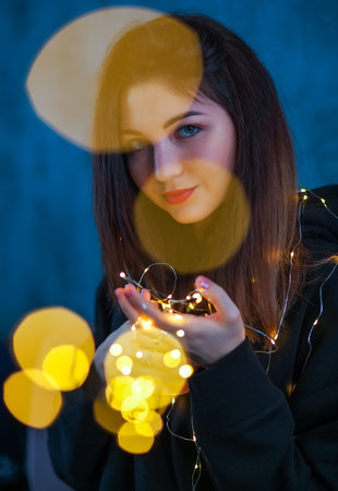 Beautiful girl with a Christmas garlandの写真素材