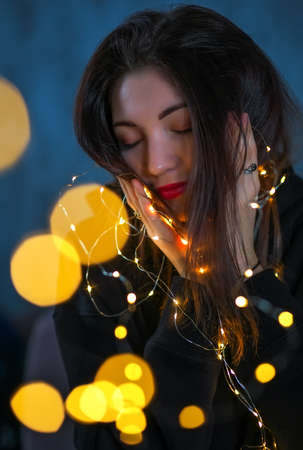 Beautiful girl with a Christmas garlandの写真素材
