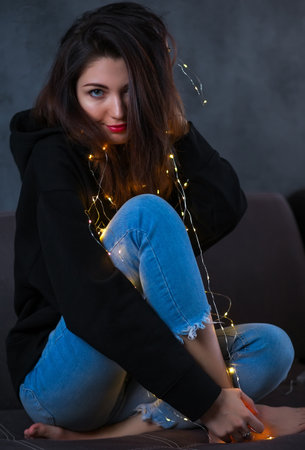 Beautiful girl with a Christmas garlandの写真素材