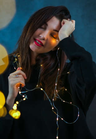 Beautiful girl with a Christmas garlandの写真素材