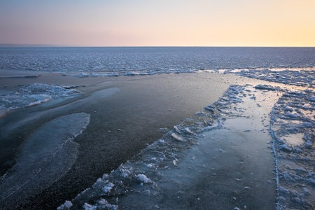 Sunrise and frozen sea. Beautiful winter landscape with lake in morning time.の写真素材