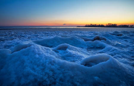 Sunrise and frozen river. Beautiful winter landscape with lake in morning time. Daybreakの写真素材