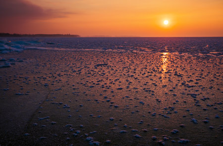 Sunrise and frozen sea. Beautiful winter landscape with lake in morning time.の写真素材
