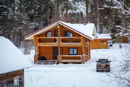 Russian Traditional log wooden house and car. Karelian village, Russiaの写真素材
