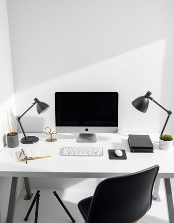 workplace with computer, lamp, notebook and stationery on tableの写真素材