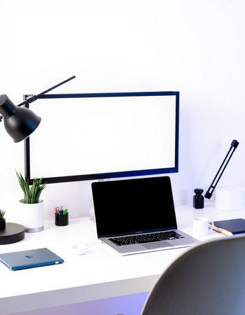 workplace with blank screen laptop, lamp and stationery on table
