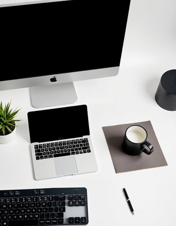 Top view of modern office desk with computer, supplies and coffee cup.の写真素材