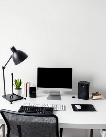 workplace with computer, keyboard, mouse, lamp and plant on table