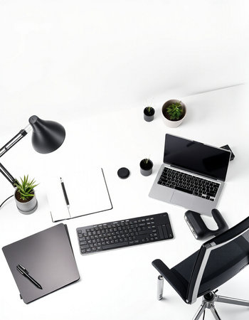 Top view of modern workplace with laptop, tablet, notebook, coffee cup and other items on white backgroundの写真素材